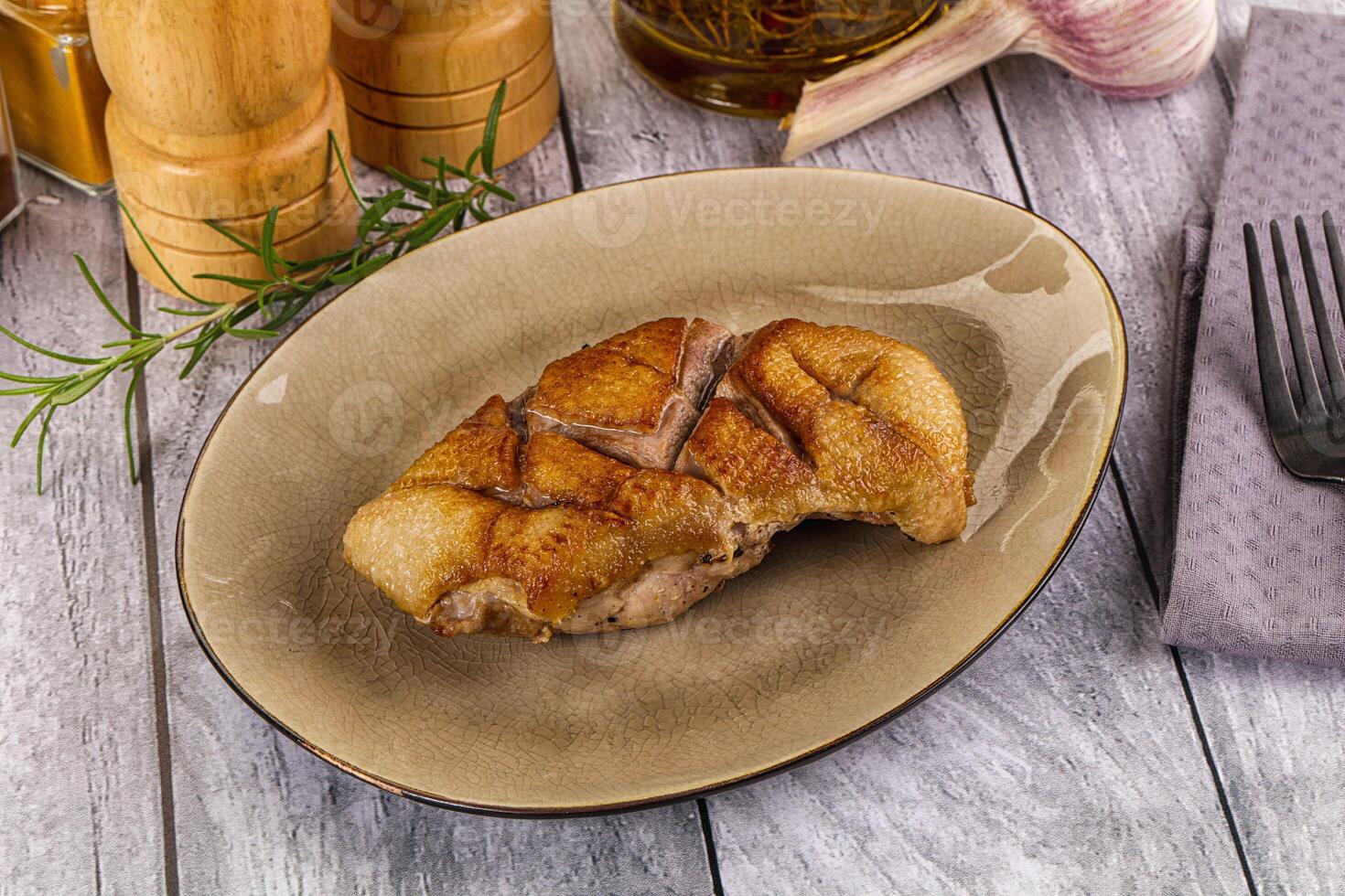 A plate with a piece of meat on it photo