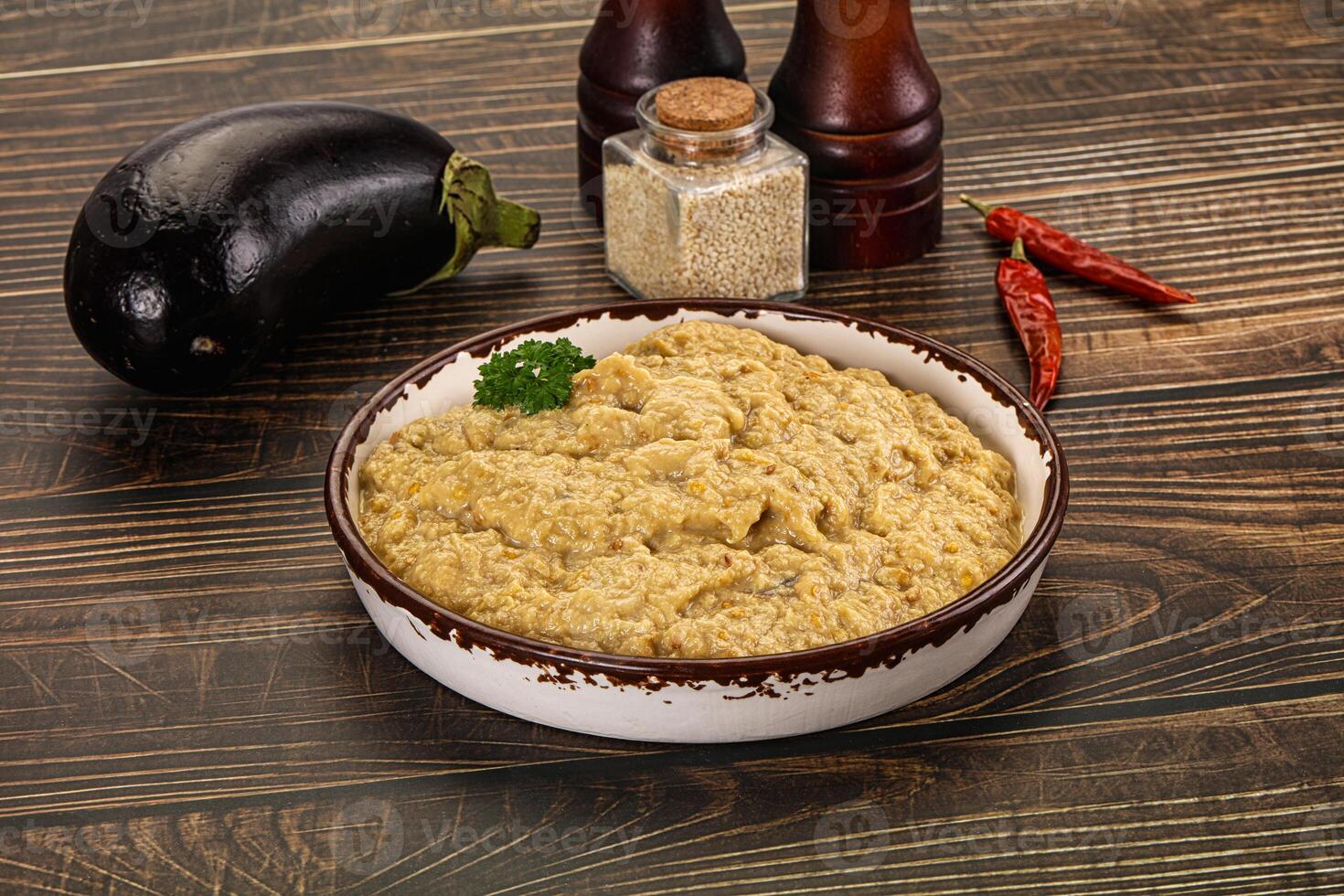 A bowl of food on a table with spices and other ingredients photo