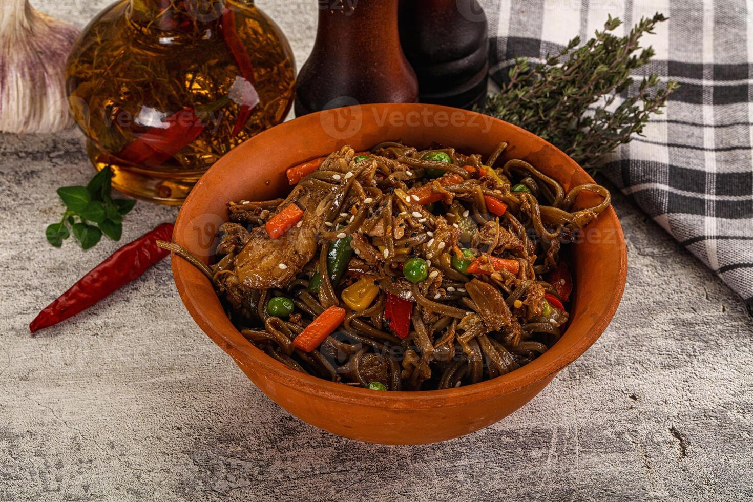 A bowl of noodles with vegetables and garlic photo