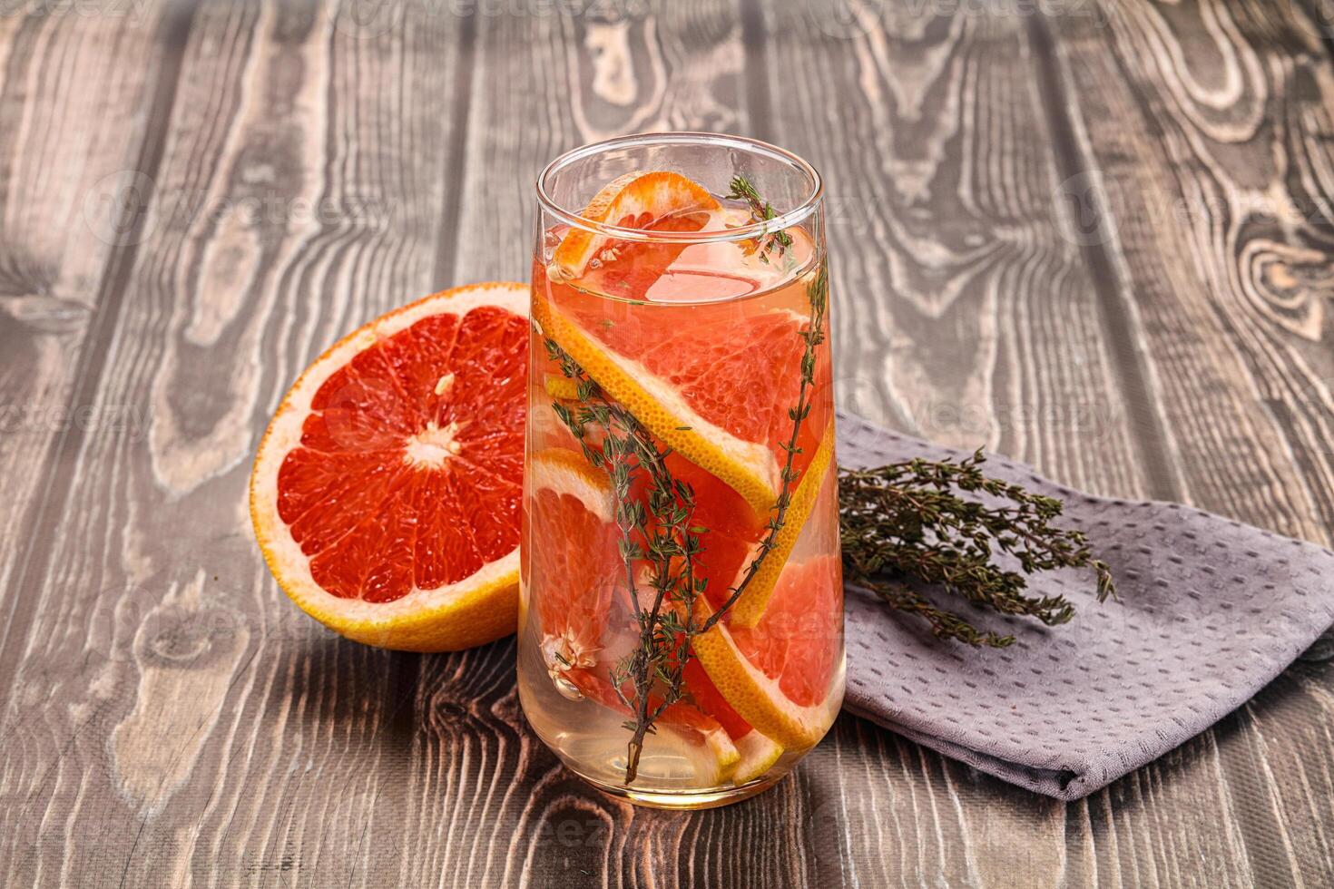 A glass of orange juice with a grapefruit slice photo