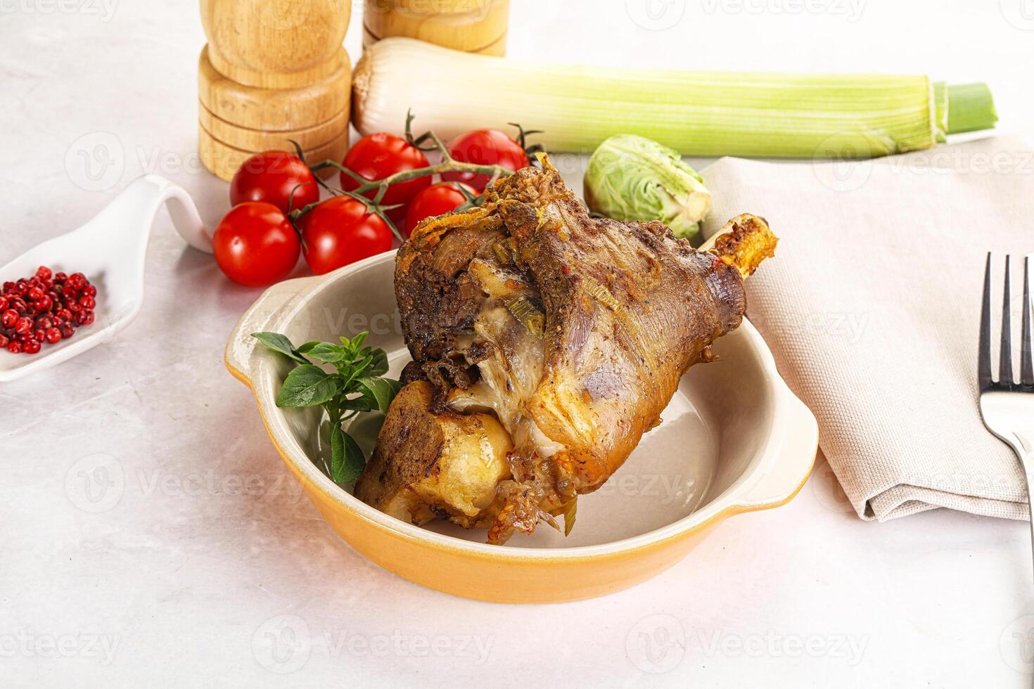 A bowl of meat with vegetables and a fork photo