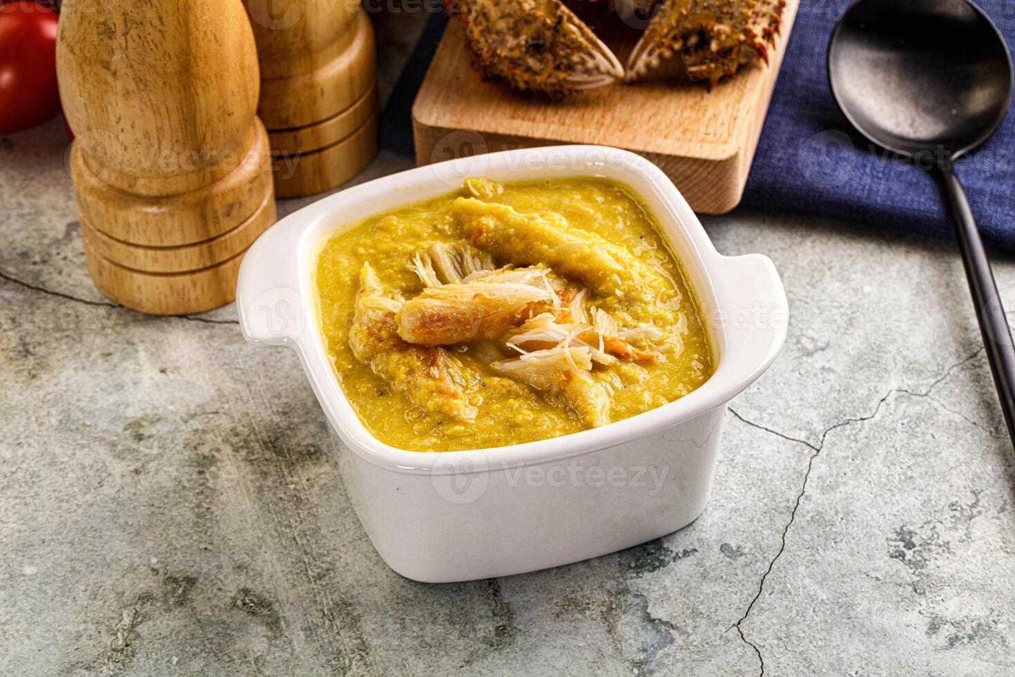 A bowl of soup with bread and a spoon photo