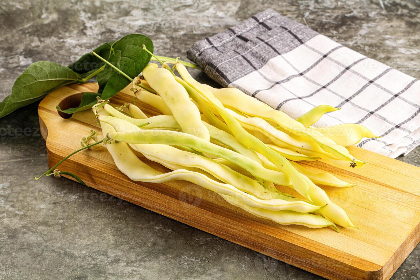 A wooden cutting board with beans on it photo