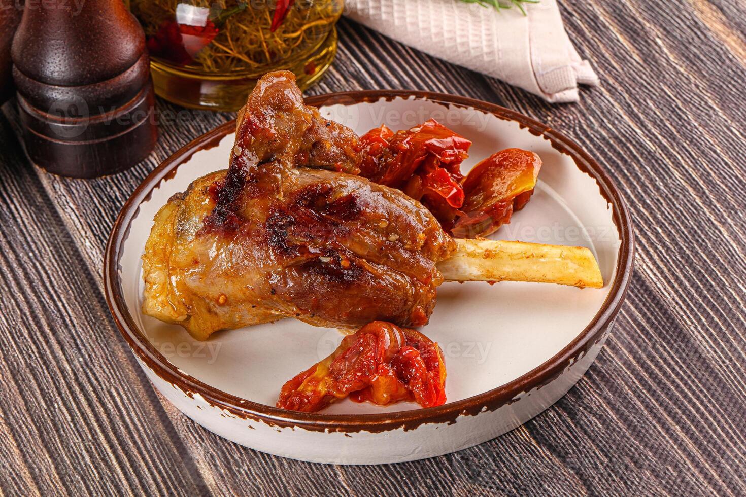 A plate of food with meat and tomatoes photo