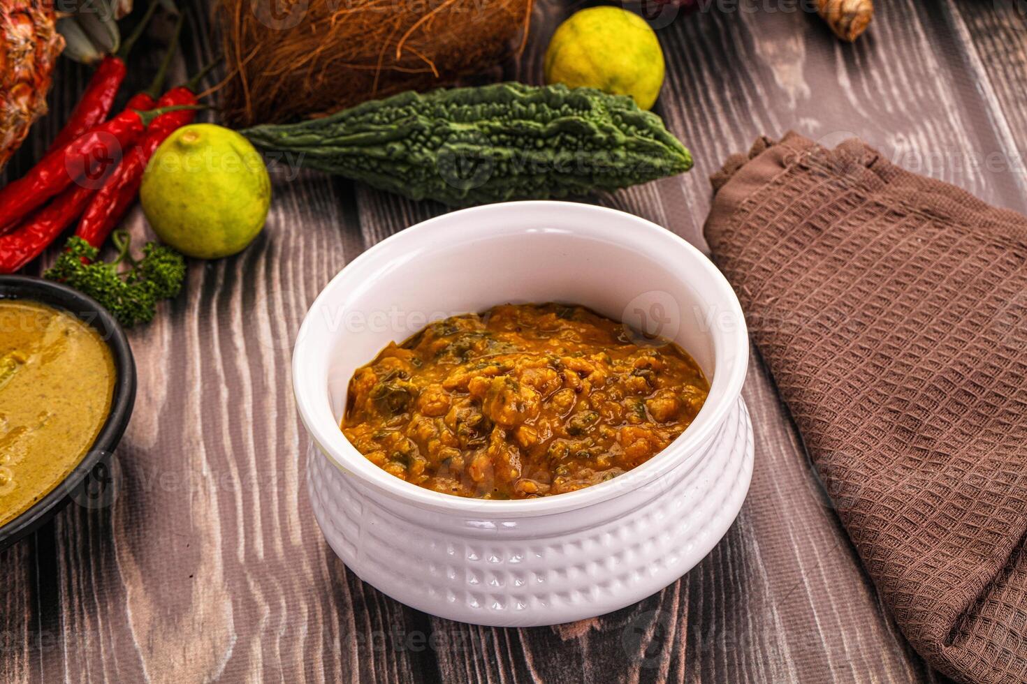 A bowl of food on a table next to a bowl of soup photo