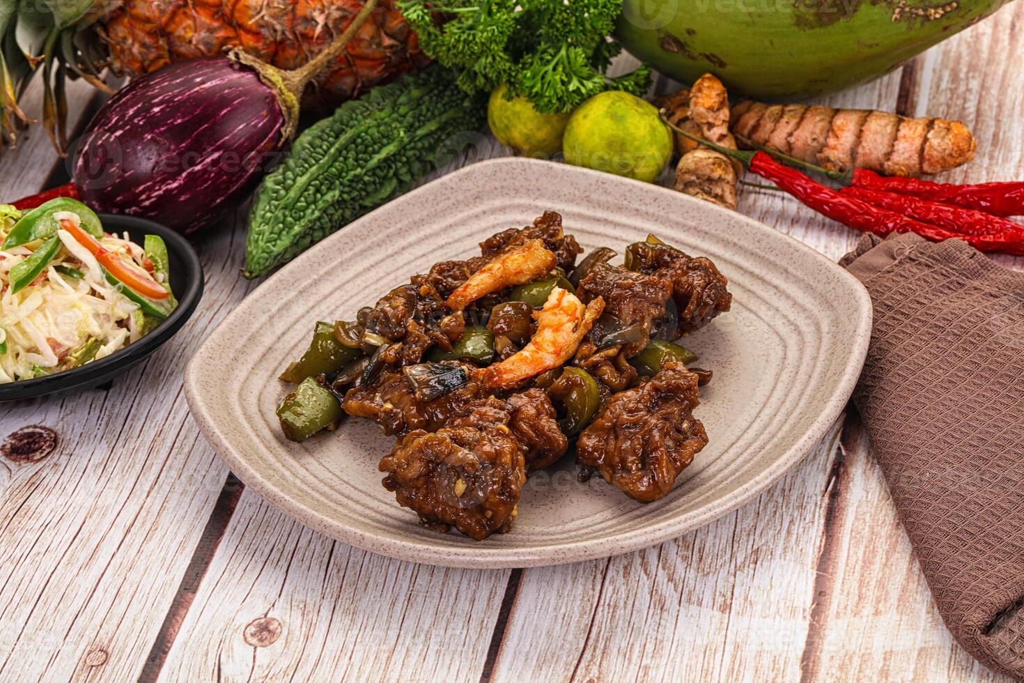 A plate of food on a table with other food photo
