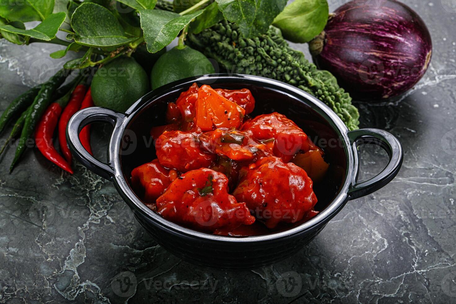 A bowl of food with vegetables and spices photo
