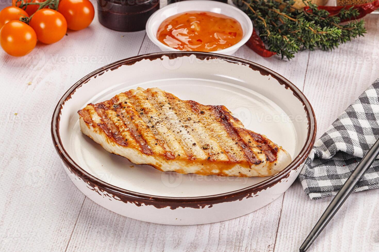 A plate of food with a piece of meat on it photo