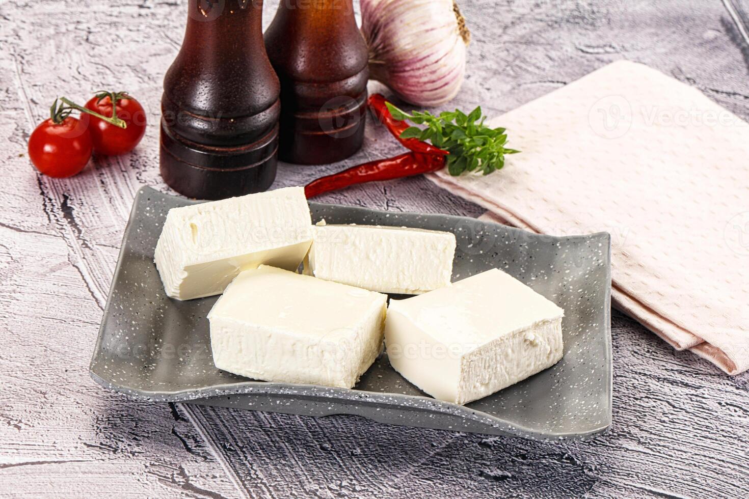 A plate of cheese and tomatoes on a table photo
