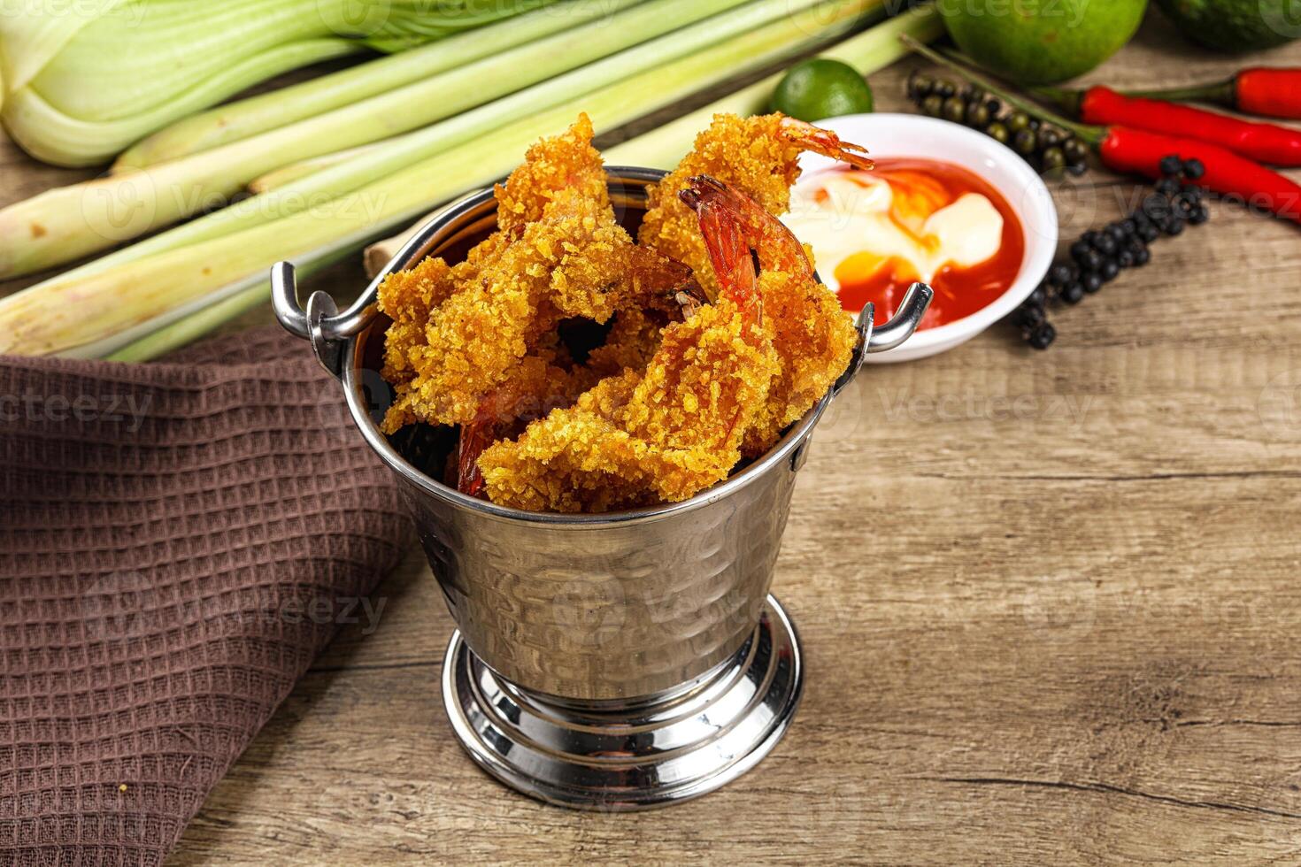 A silver container with fried shrimp and other vegetables photo