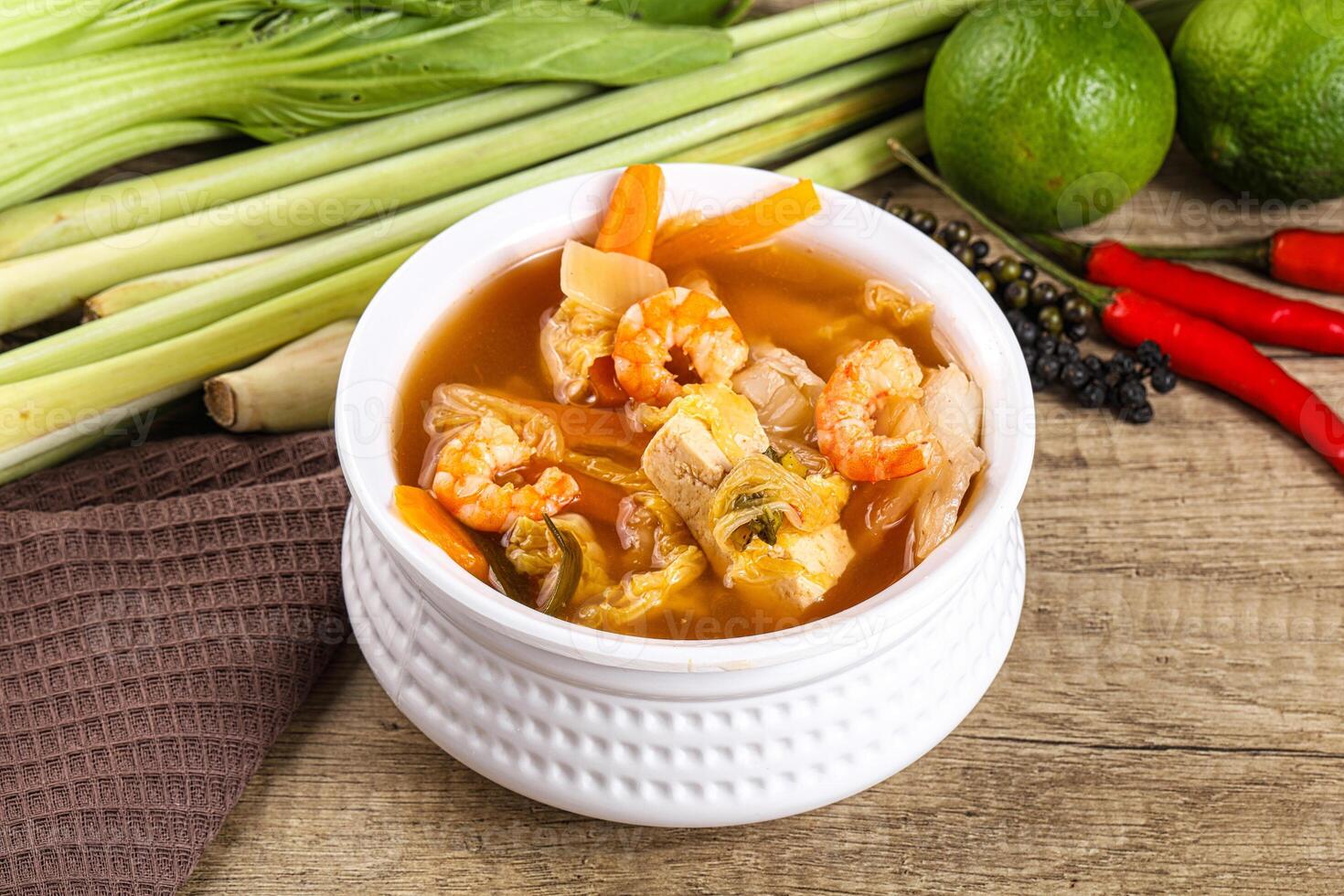 A bowl of soup with vegetables and shrimp photo