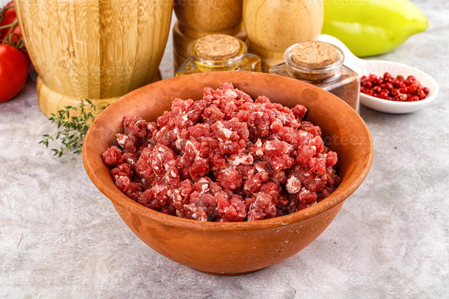 A bowl of ground beef with spices and herbs photo