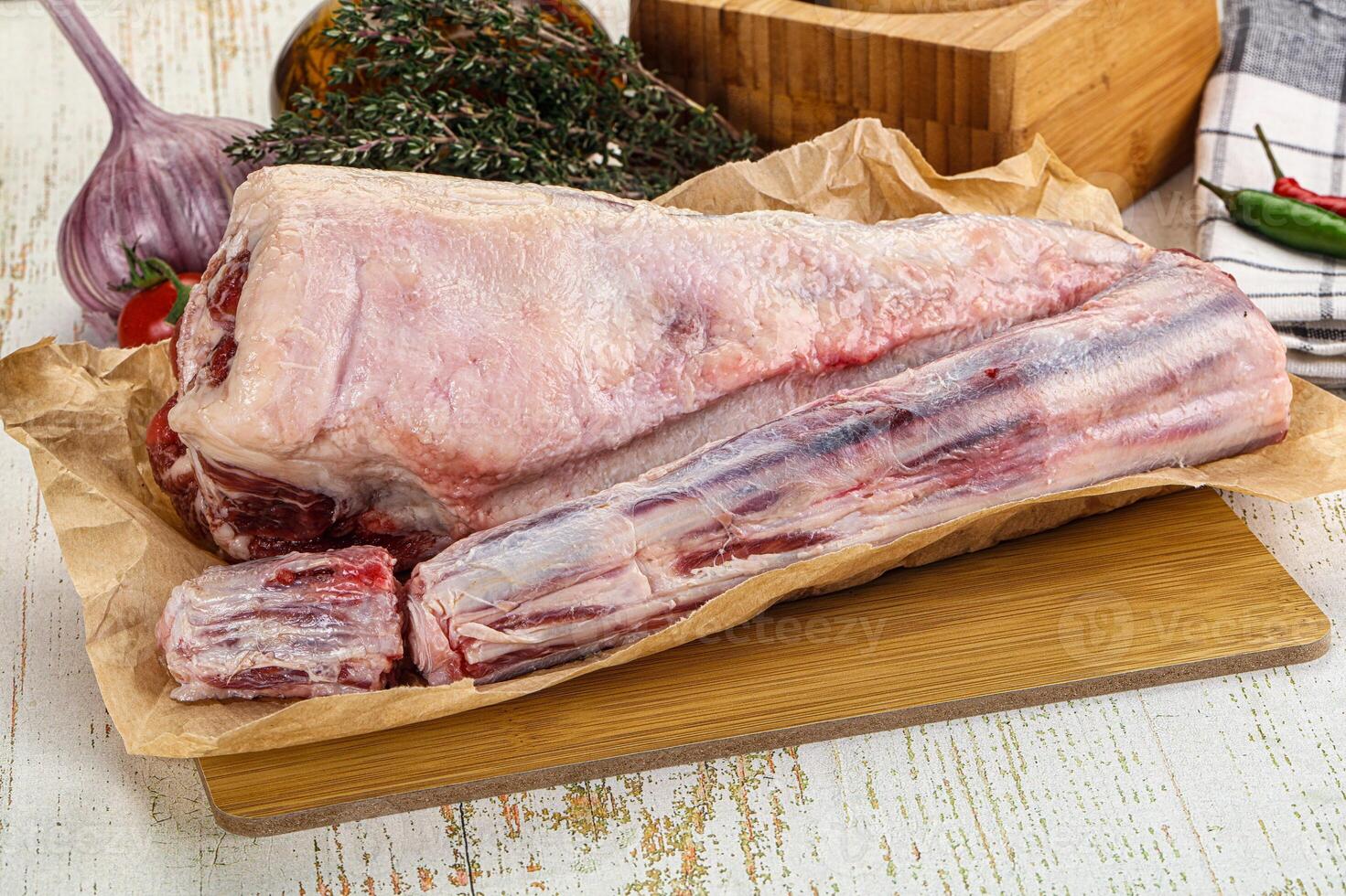 A piece of meat on a cutting board with a knife photo