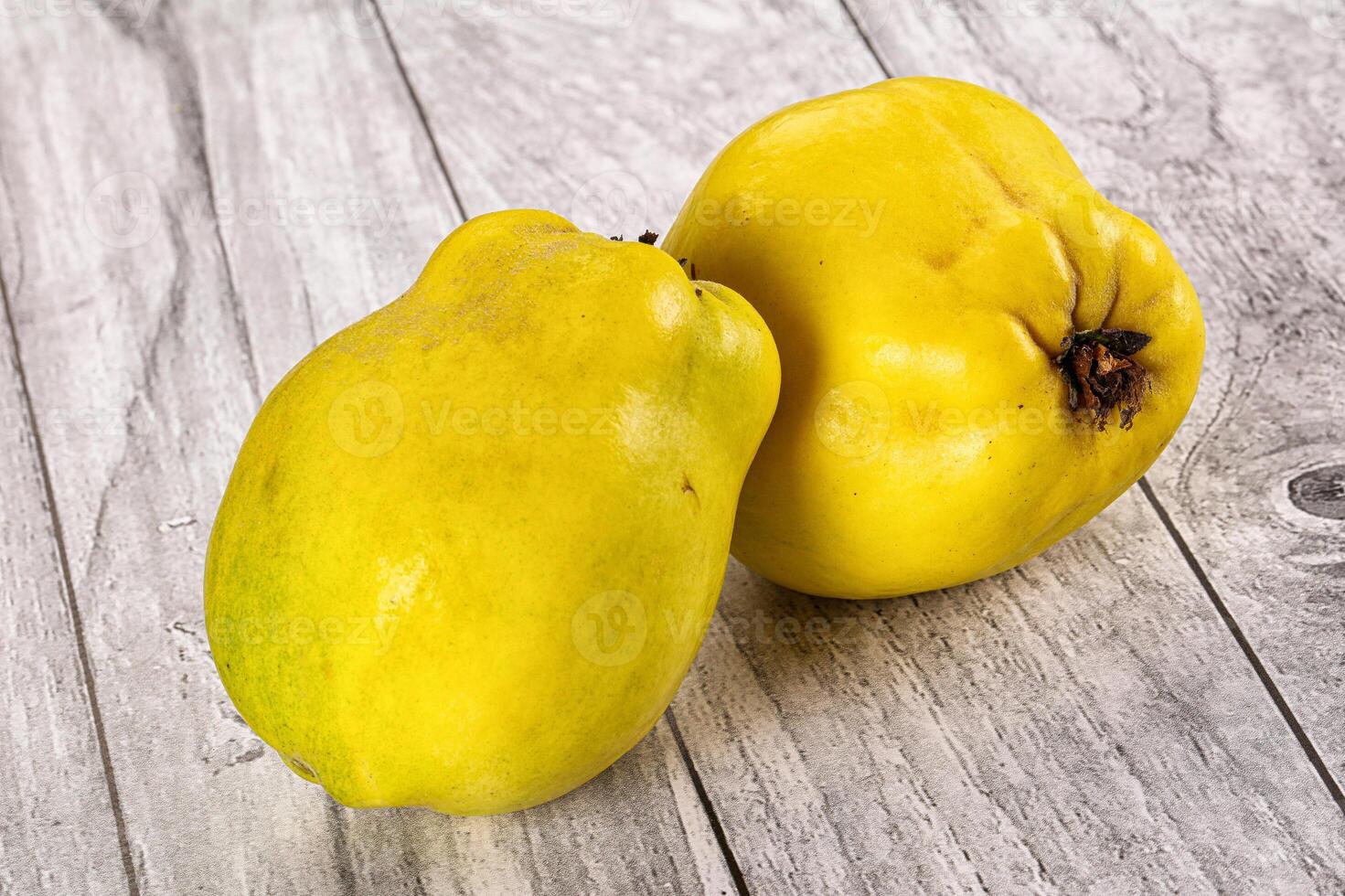Two yellow fruits on a table photo