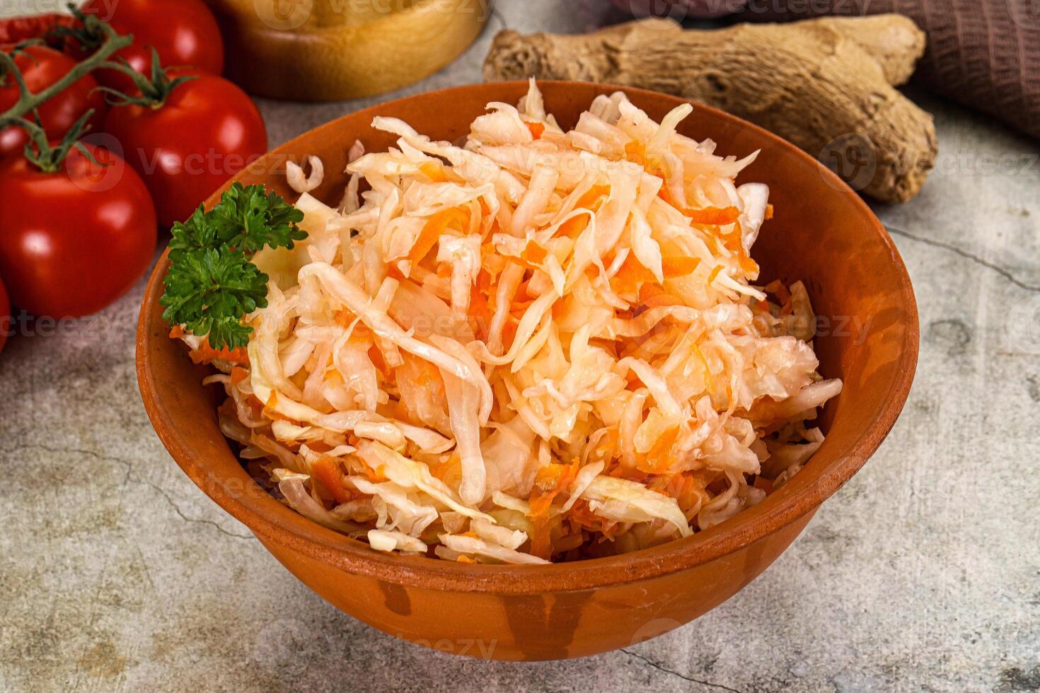 A bowl of shredded cabbage with tomatoes and herbs photo