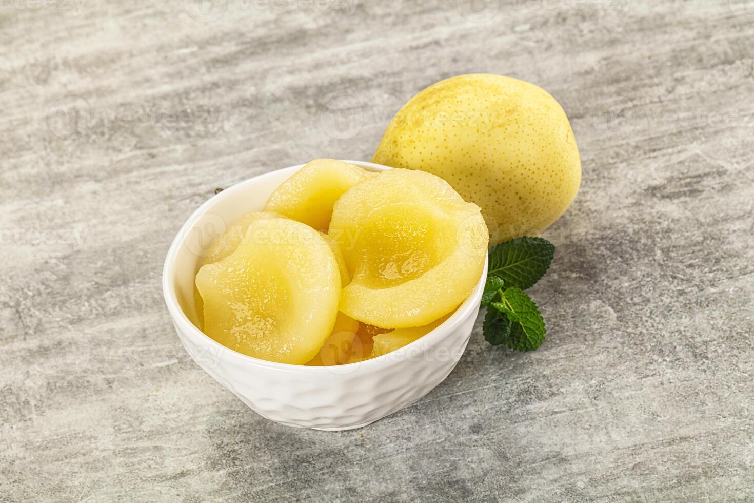 A bowl of peeled peaches and a lemon photo