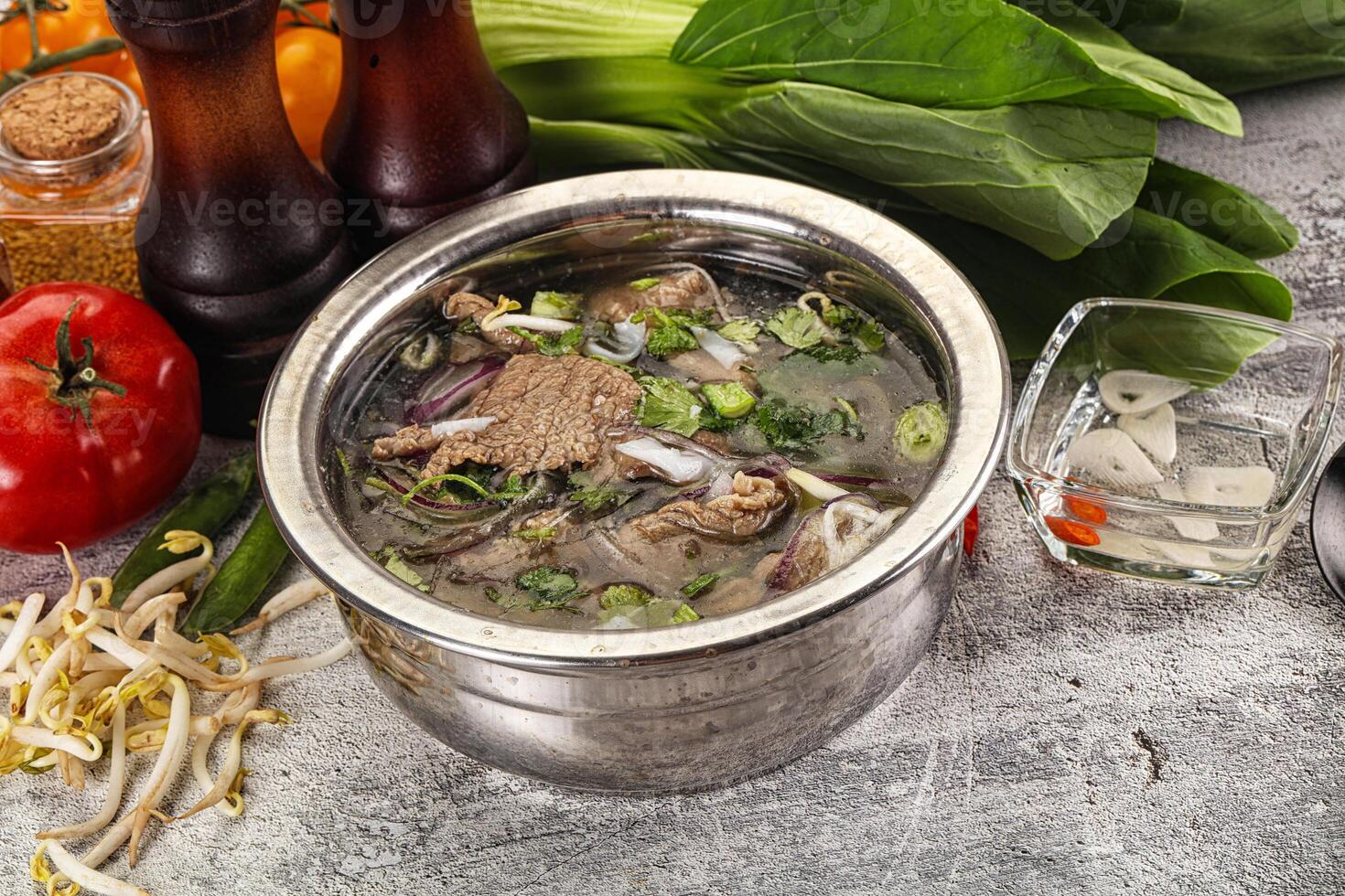 A bowl of soup with vegetables and meat photo