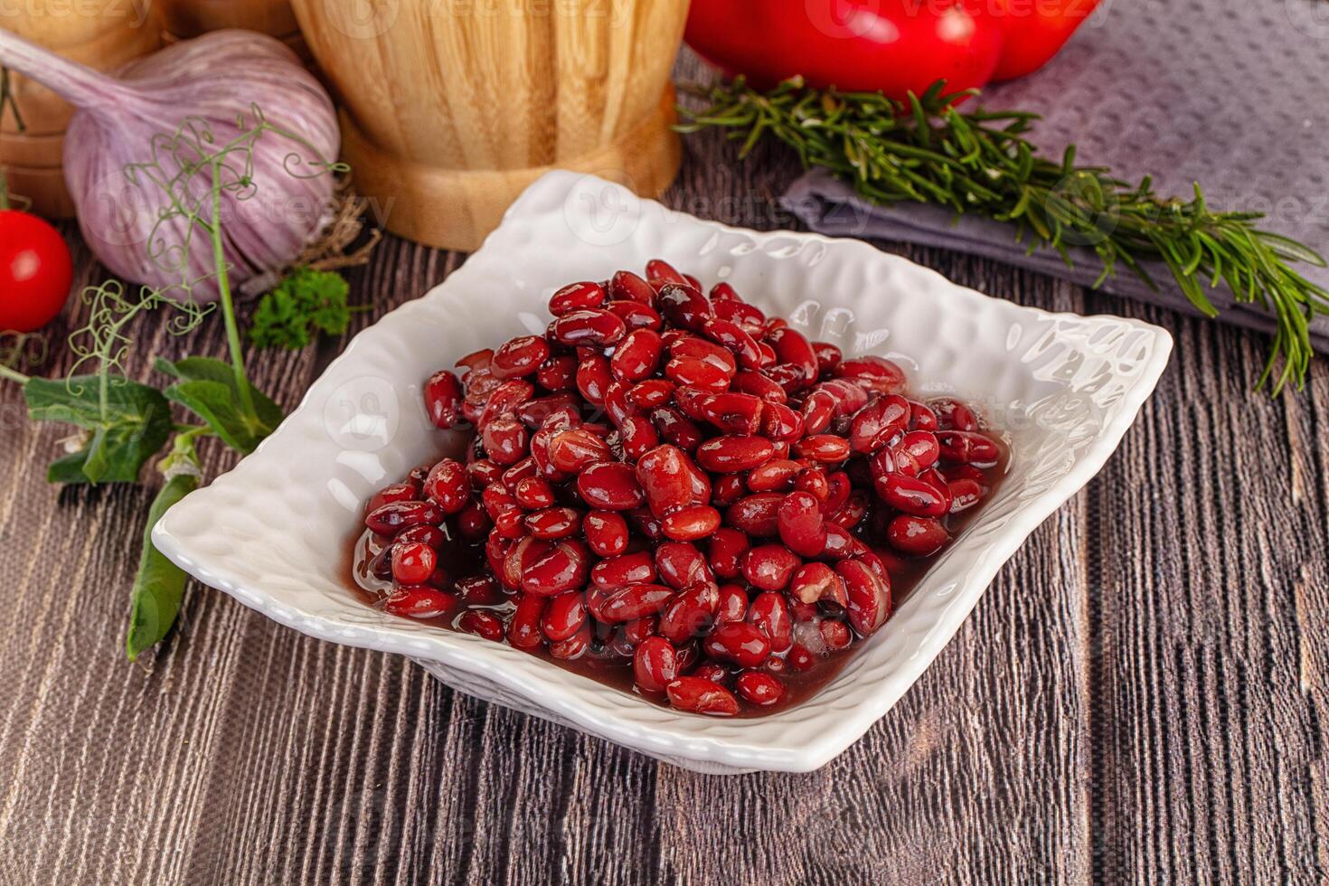 A bowl of beans and a bowl of tomatoes photo