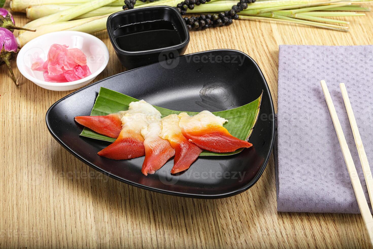 A plate of sushi with chopsticks on a table photo