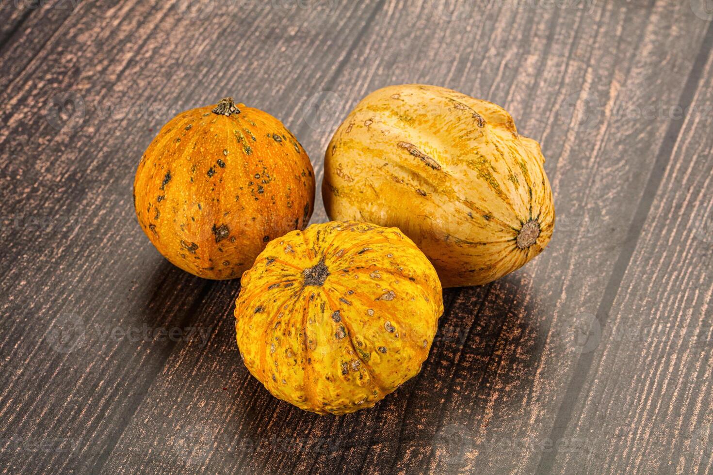 Three different types of squash on a wooden table photo