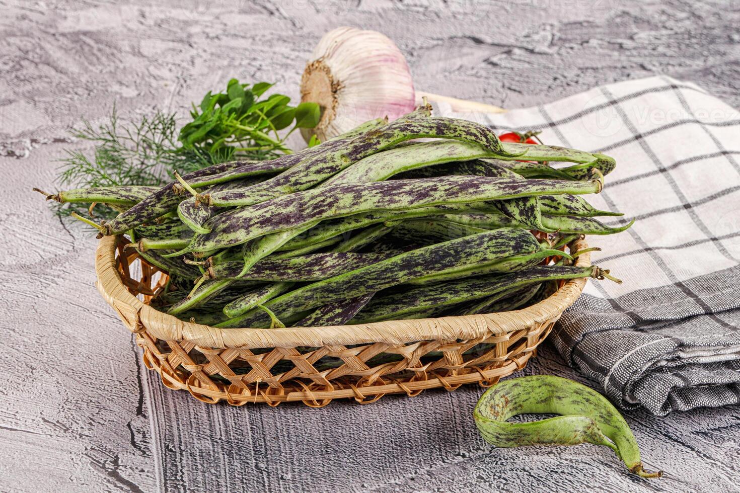 A basket filled with green beans and garlic photo
