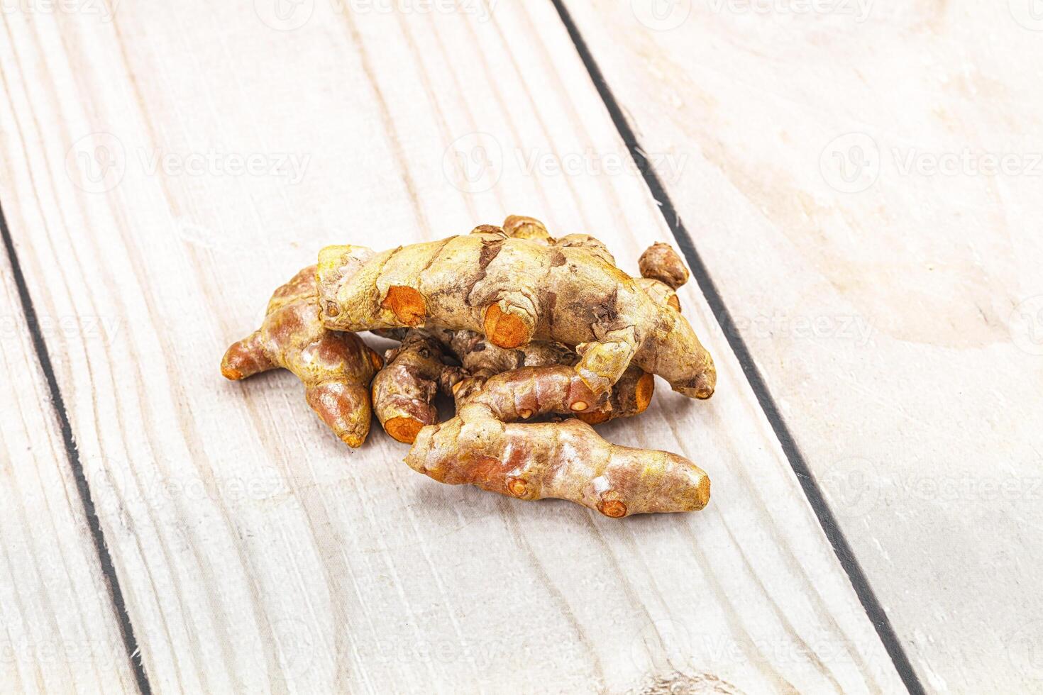 A pile of ginger root on a wooden table photo
