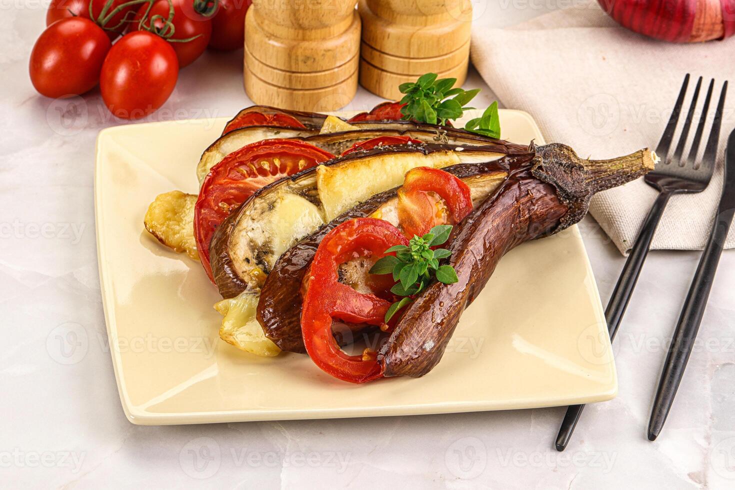 A plate with a steak, vegetables and a knife and fork photo