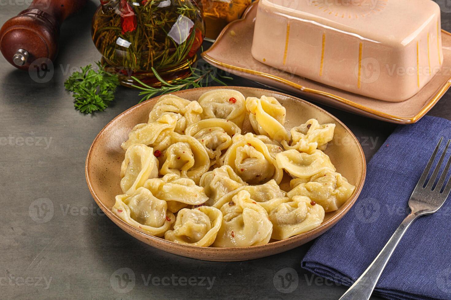 A bowl of pasta with a fork and knife photo