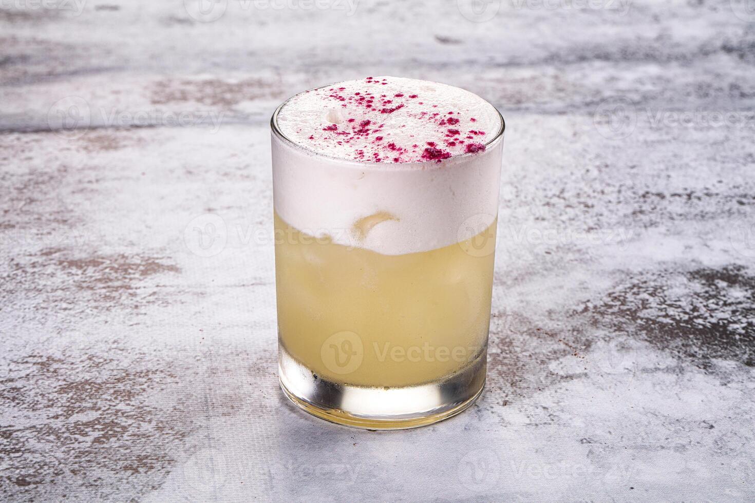 A cocktail with a white liquid and pink sprinkles photo