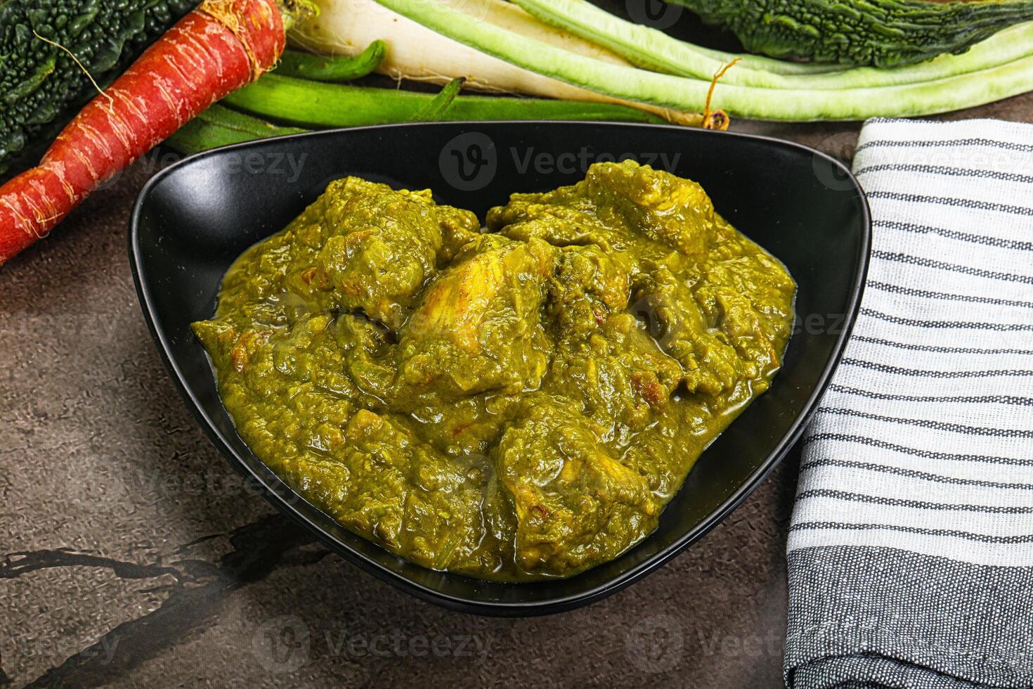 A bowl of food with vegetables and a towel photo