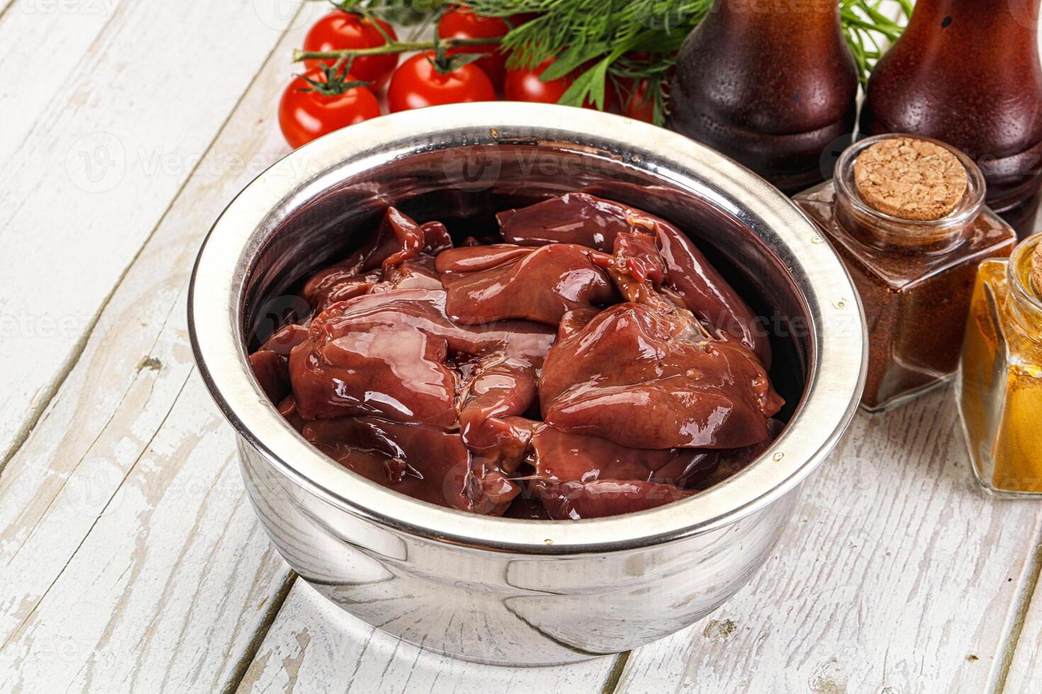 A metal container filled with meat and spices photo