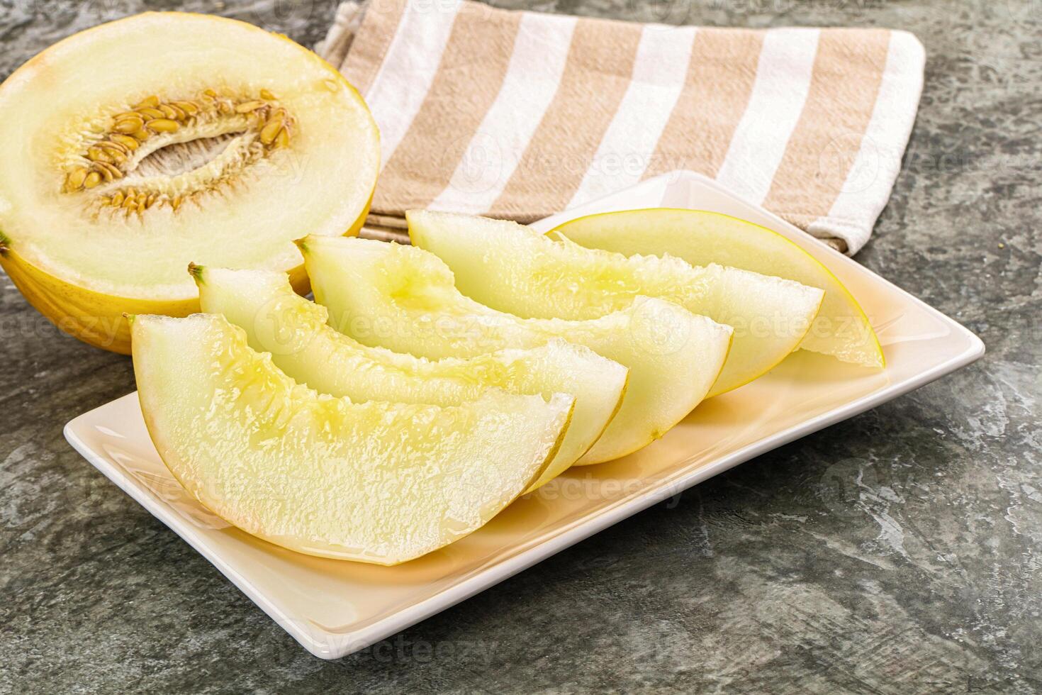 A white plate with a slice of melon on it photo