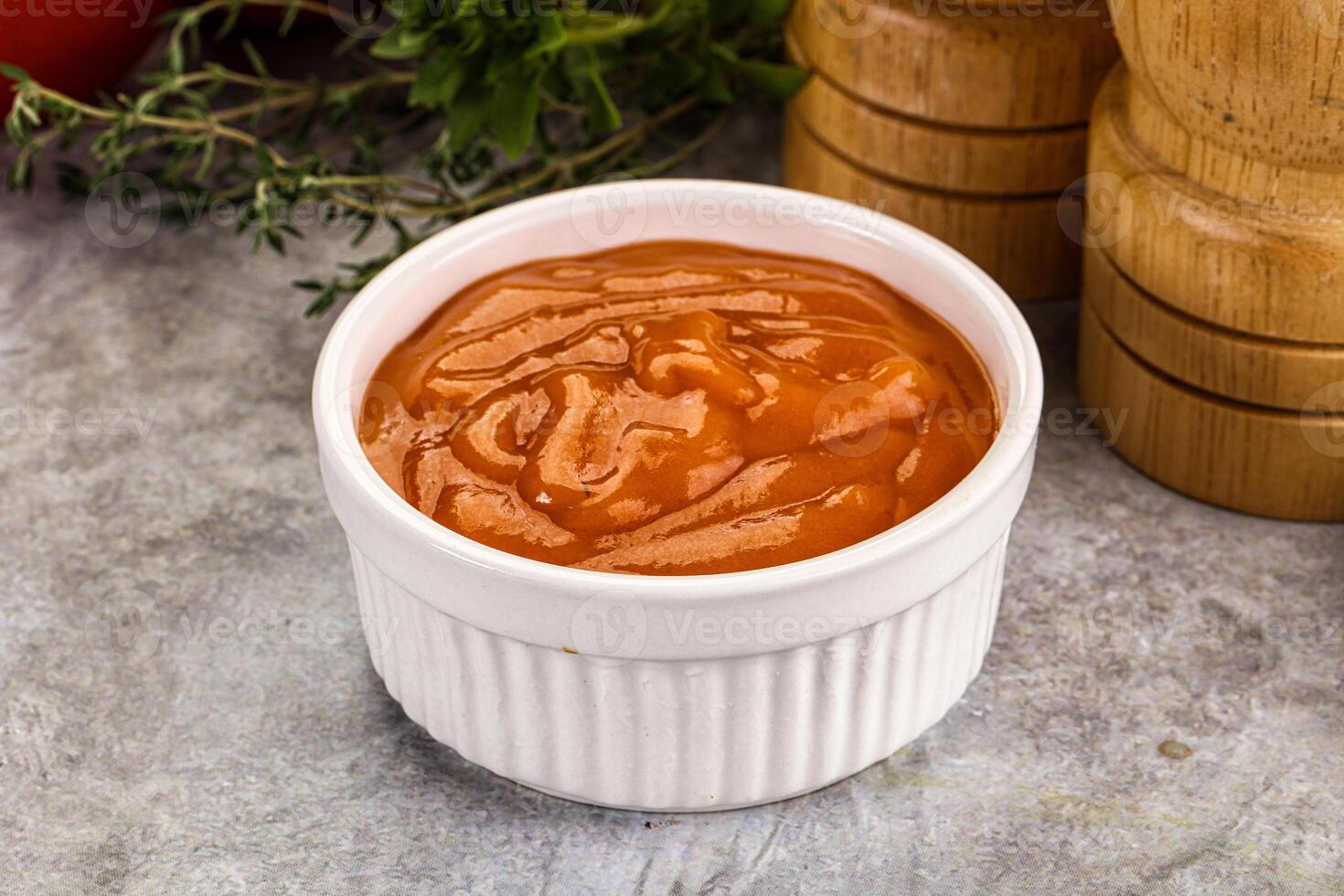 A bowl of sauce with tomatoes and spices photo