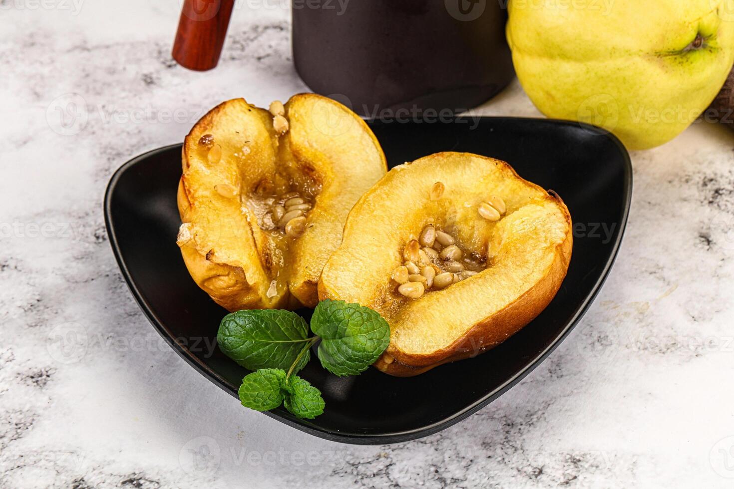 A black plate with two halves of a pear photo