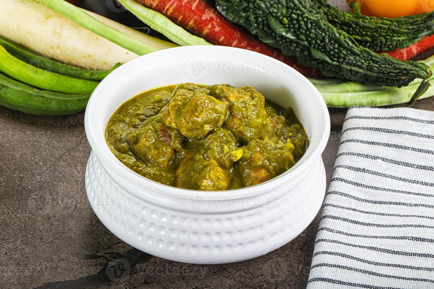 A bowl of food with vegetables and a towel photo