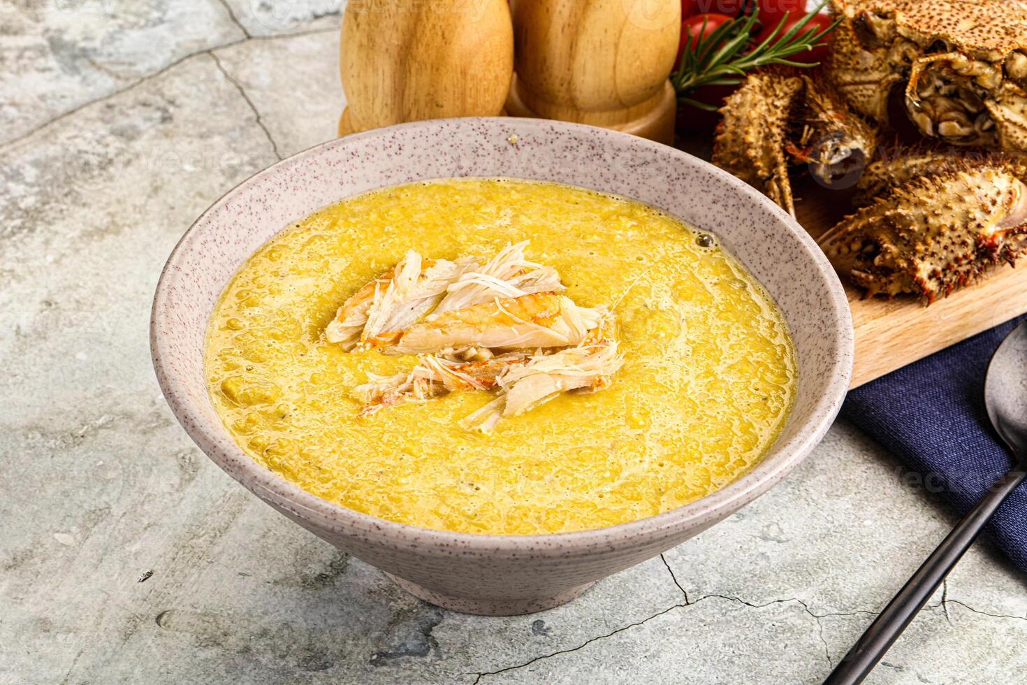 A bowl of soup with chicken and bread photo