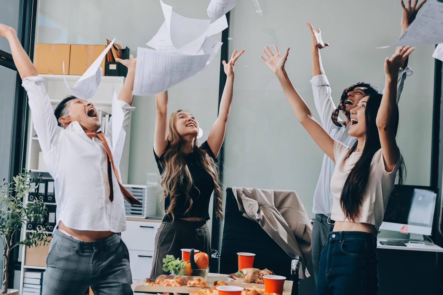 Group of business people celebrating in office photo