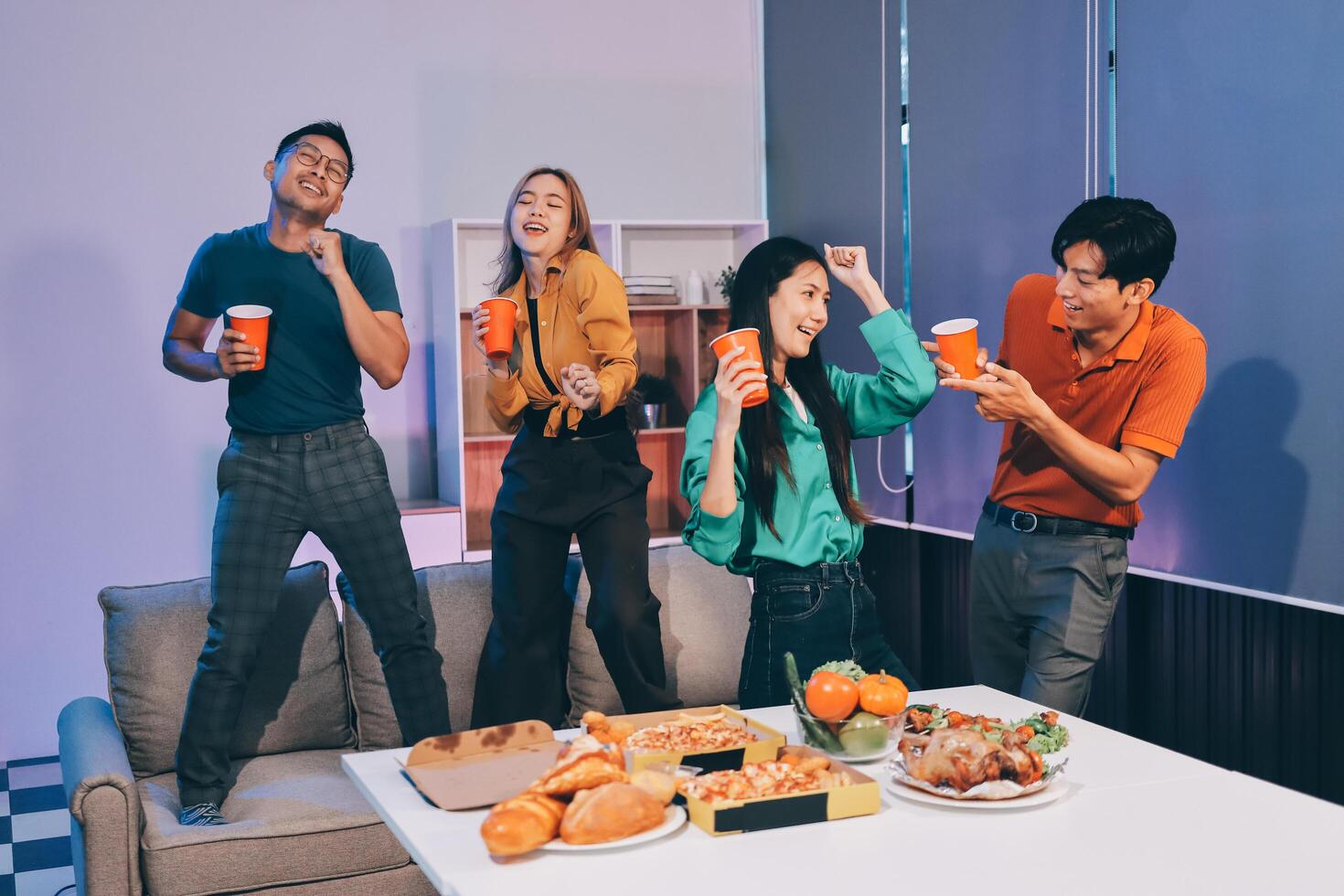 Four friends having fun with food and drinks photo