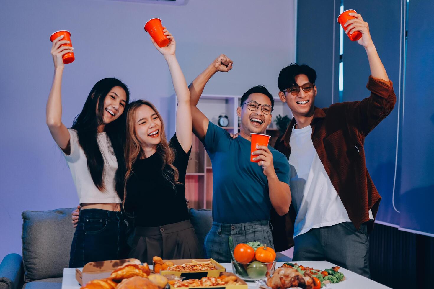 Four friends celebrating thanksgiving with food and drinks photo