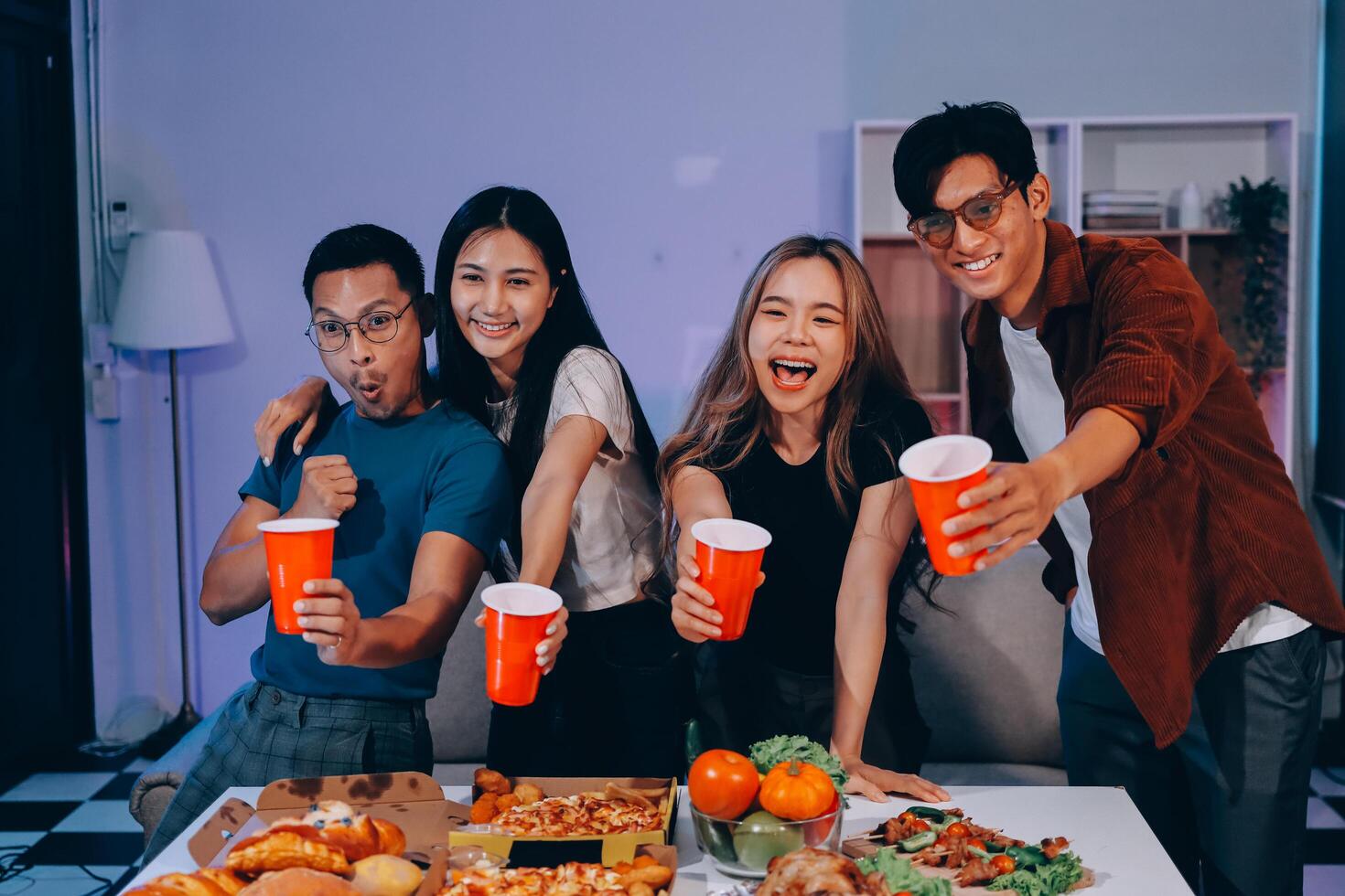 A group of friends enjoying pizza and drinks photo