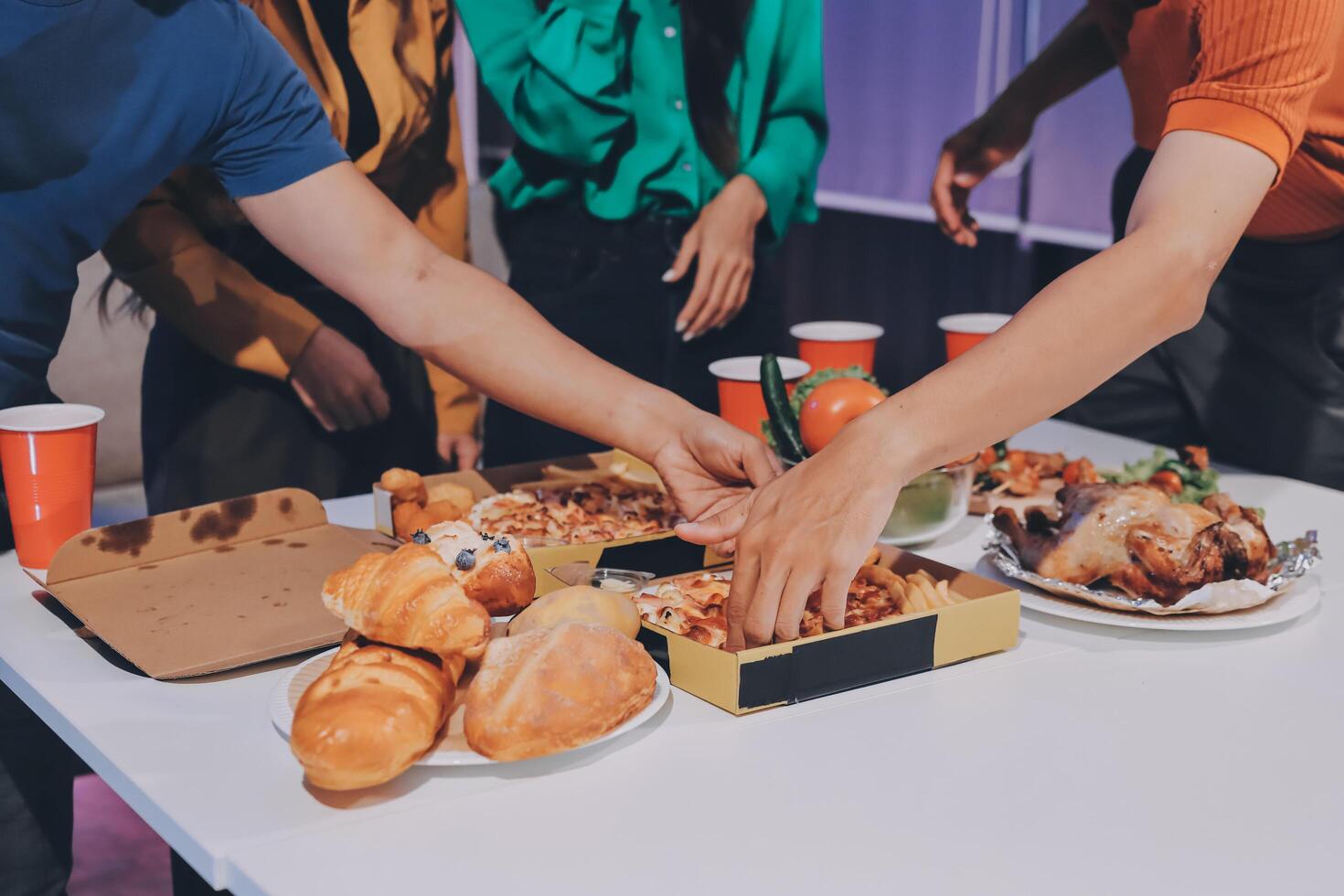 People eating food at a table with plates of food photo