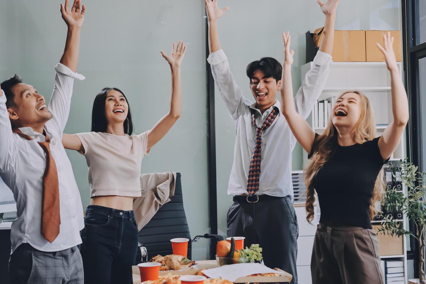 Group of young people celebrating in office photo