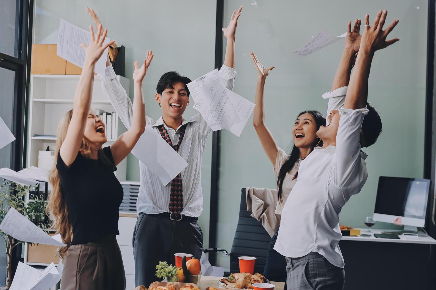 Happy asian business people celebrating after a successful meeting photo