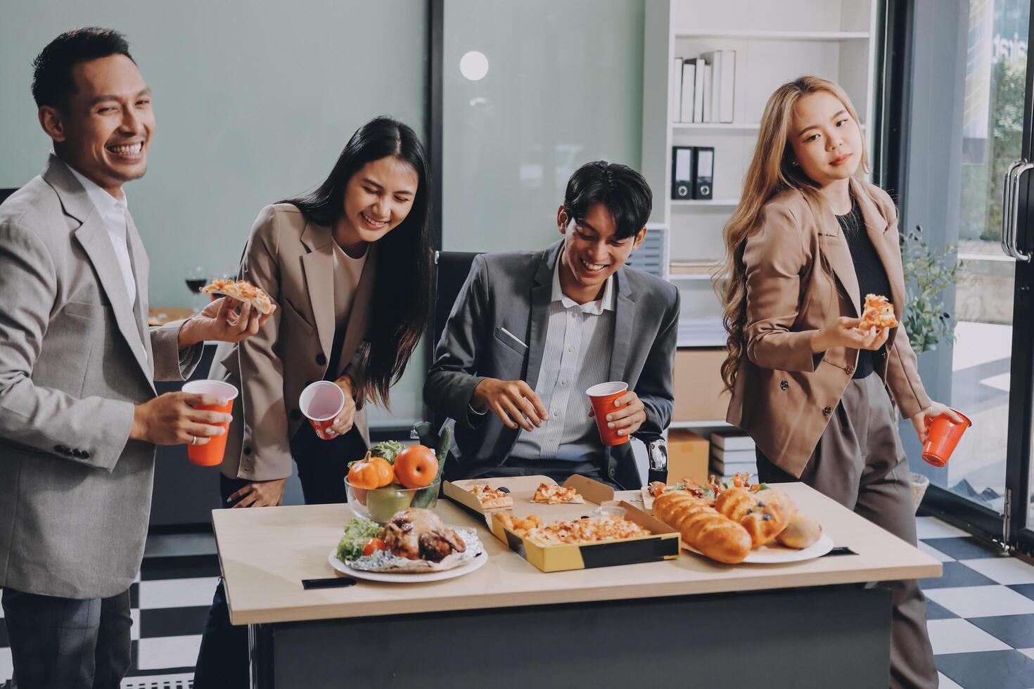 Group of business people eating food in office photo
