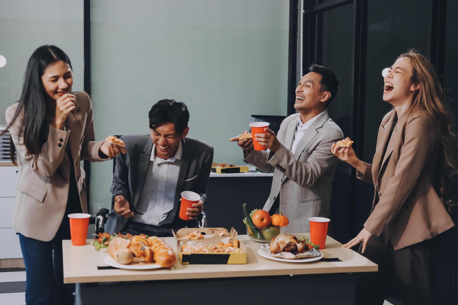 Group of business people eating pizza and drinking coffee photo