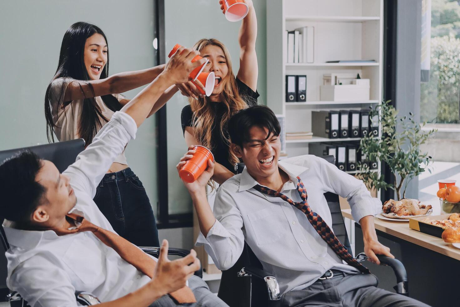 A group of people in an office having fun photo