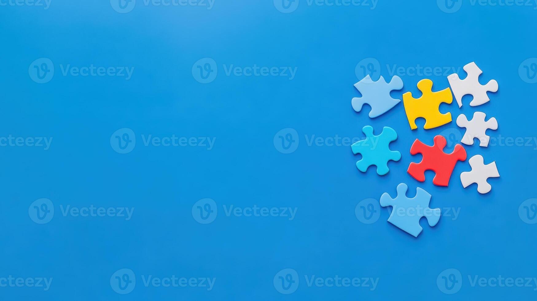Colorful puzzle pieces scattered on a blue background creating a playful and creative atmosphere for assembly photo
