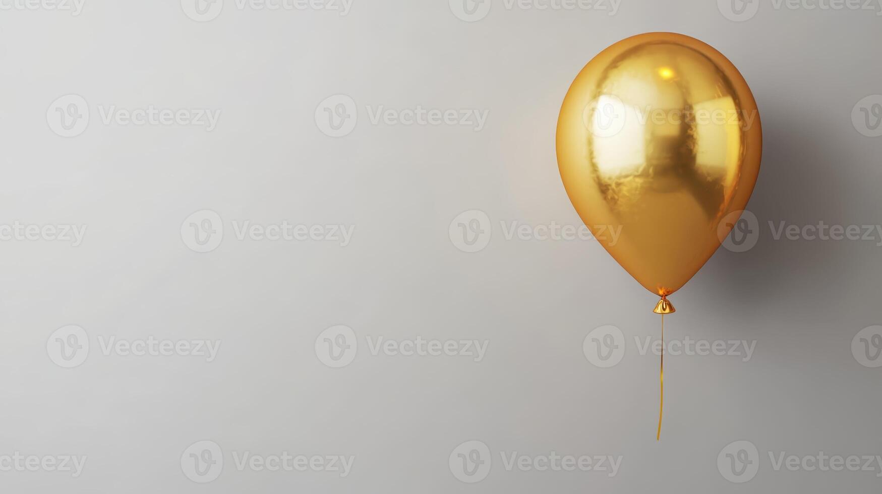 Golden balloon floating near a plain grey wall creating a feeling of celebration and joy in the atmosphere during a festive gathering photo
