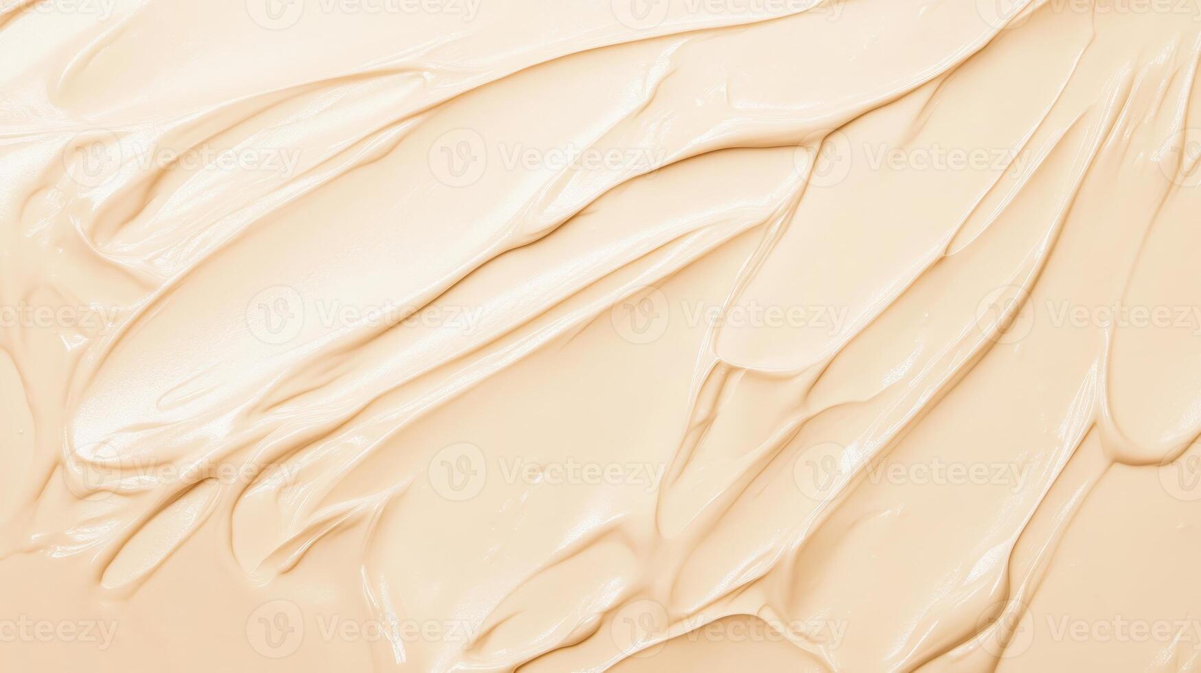Creamy beige foundation spreads smoothly on a surface, showcasing its rich texture in a soft light environment during a makeup application photo