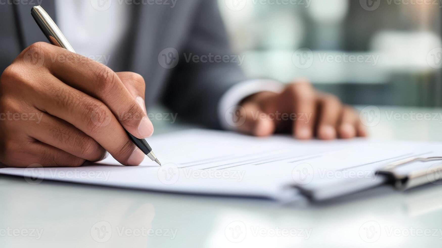 Composing significant documents while seated at a desk amidst the hustle and bustle of a hectic day in a contemporary office environment photo